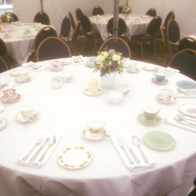 Vintage cups and saucers setup on table.