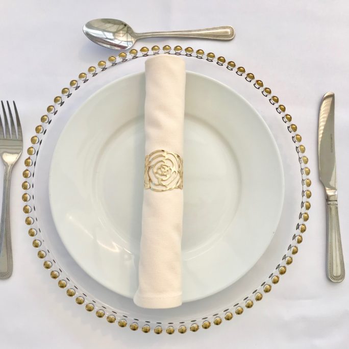 Ivory napkin with gold napkin ring